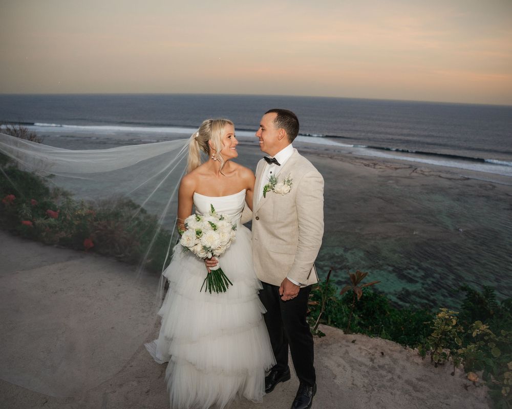 A romantic coastal wedding photoshoot featuring multiple poses of a couple along a scenic beach at sunset.