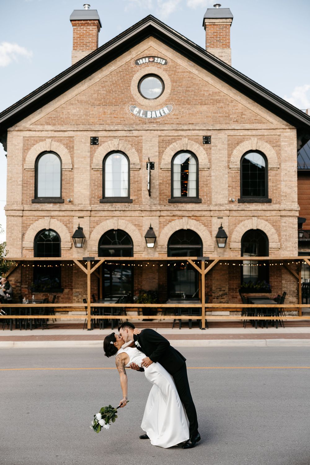 Sequence of romantic outdoor wedding photos in front of a rustic brick building with arched windows and decorative lighting.