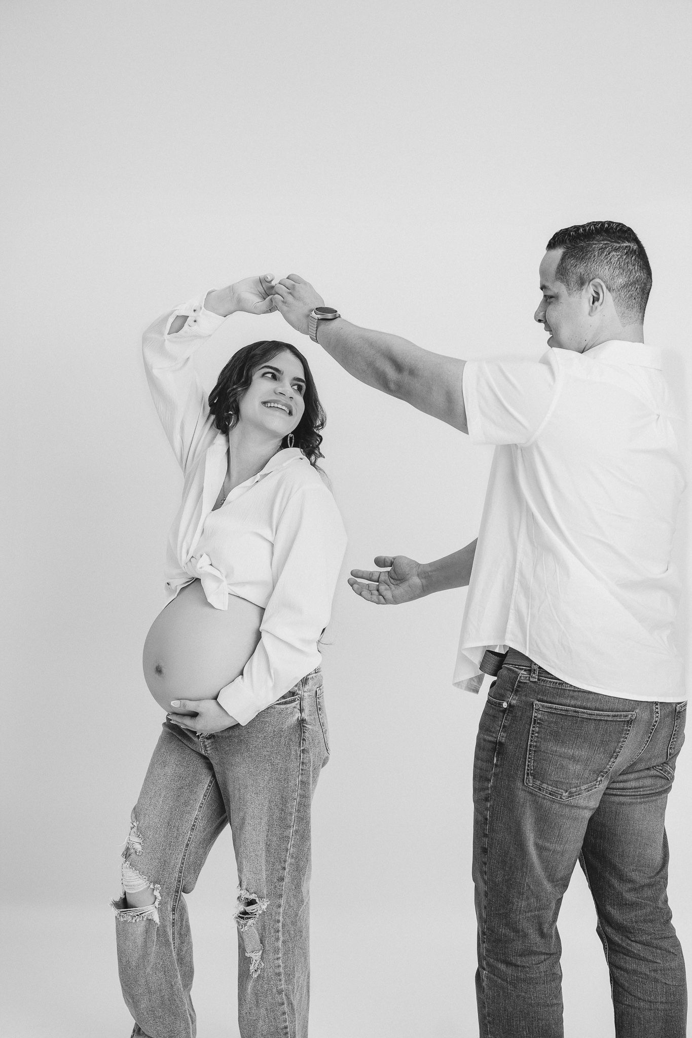 Three progressive images show playful movement and dance against a minimalist white studio background.