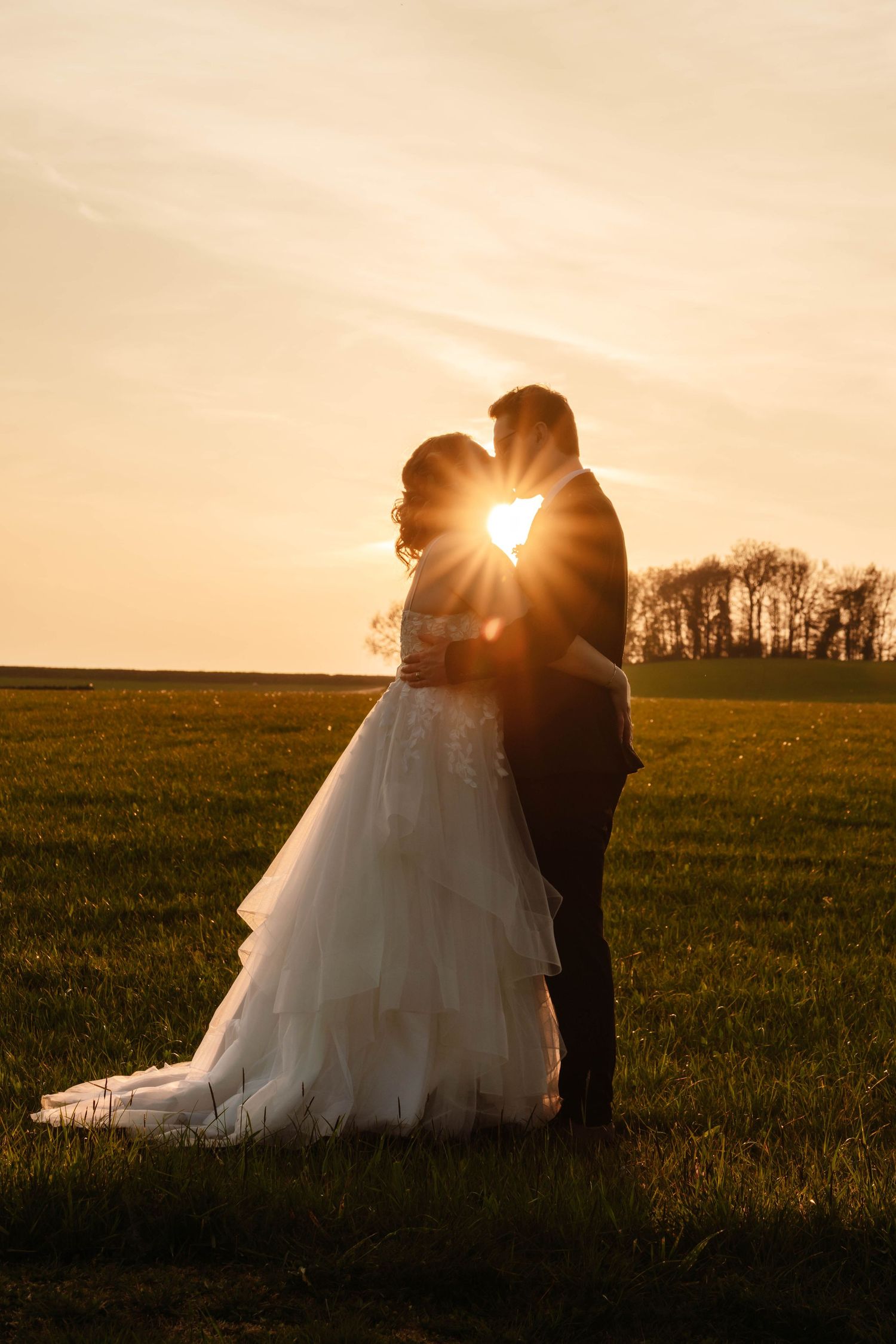 Kingscote Barn Wedding Photographer Zara Davis Photography Cotswolds Gloucestershire Cheltenham sunset portrait of couple in field
