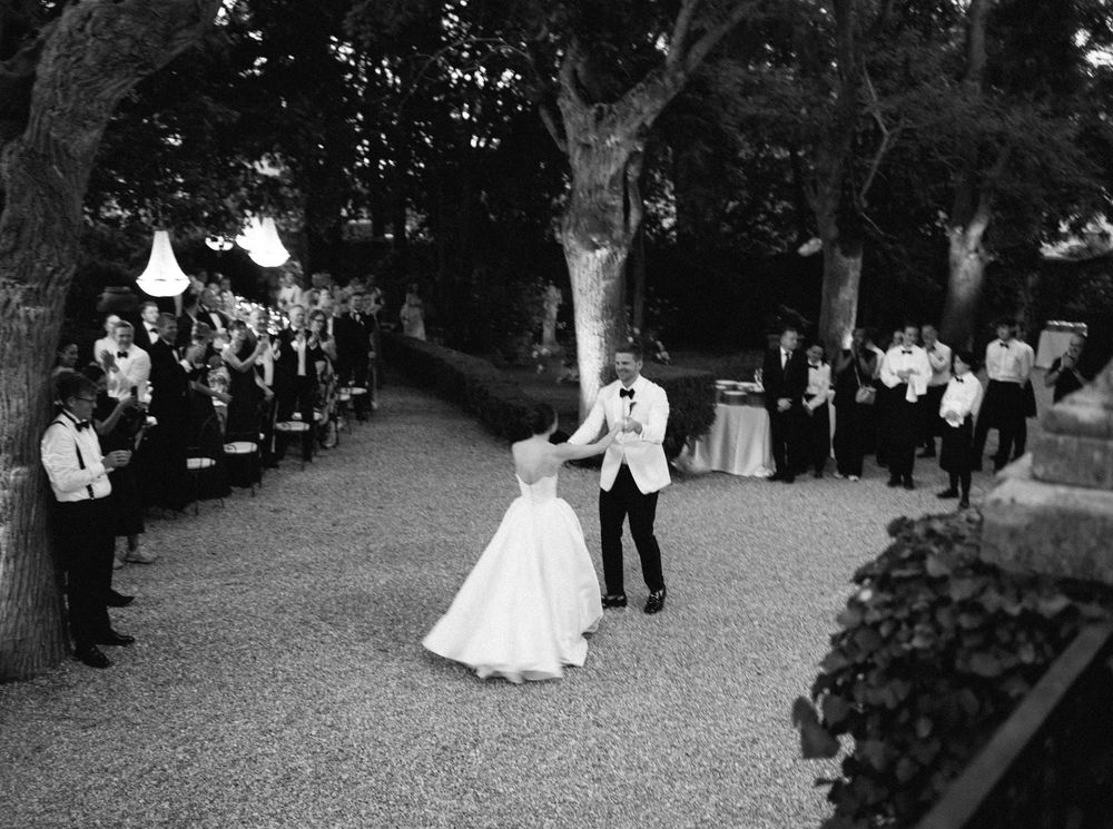 A sequence of black and white dance photos capturing romantic wedding moments in a garden setting.