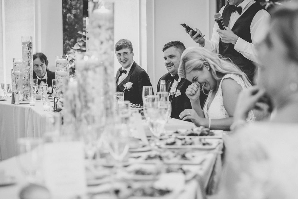bride laughing at reception black and white image