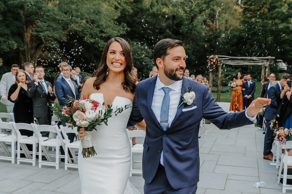 Newlyweds walk down the aisle at outdoor garden ceremony by S. Teresa Photography Siobhan Mullan at Bailey Arboretum in Long Island, NY