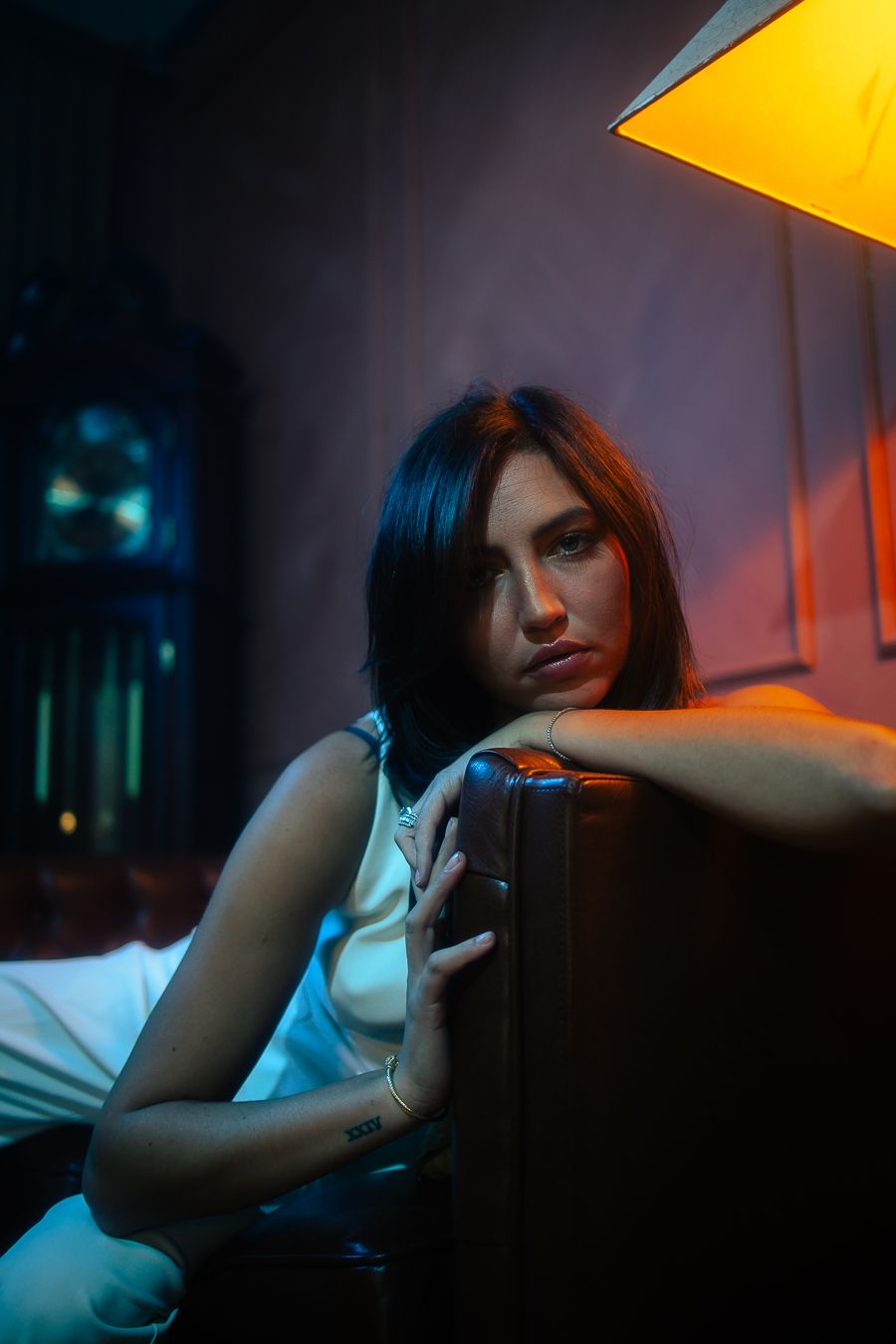 Editorial portrait of model leaning back in neon motel room, Miami cinematic style, fashion photography by Mannyportraits.