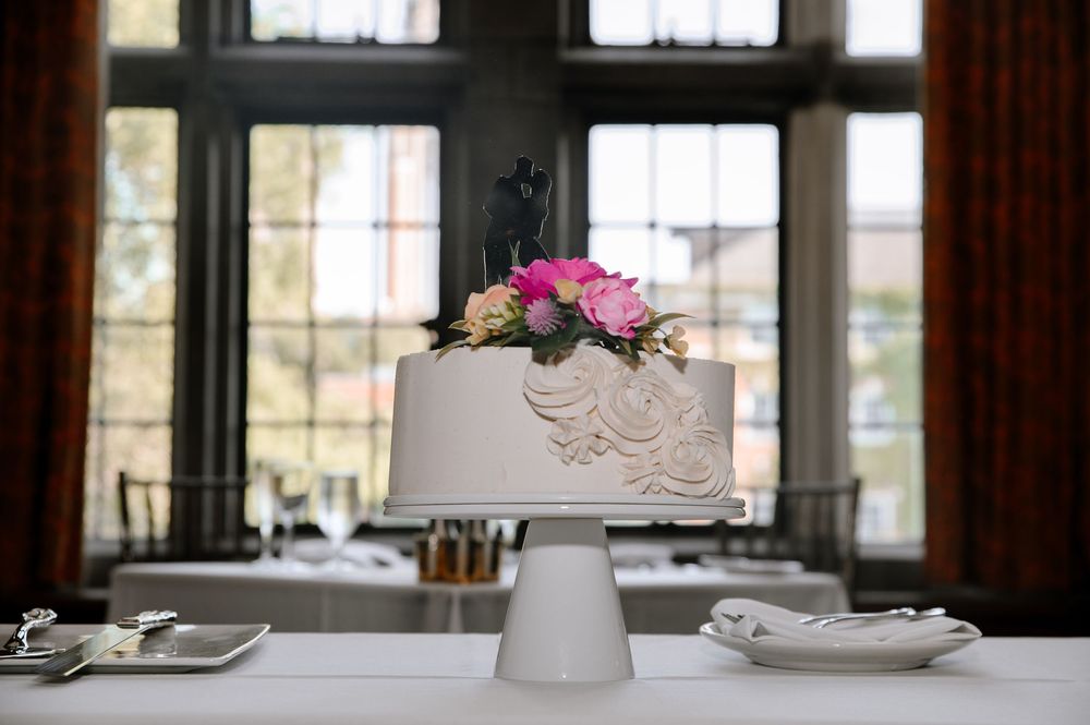 Elegant table settings with vintage doilies, white porcelain dishes, and pink floral arrangements in a bright room.