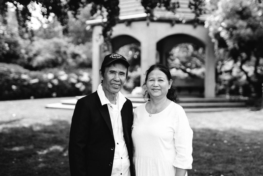 A collection of black and white outdoor portrait photos showing joyful moments and embraces between couples.