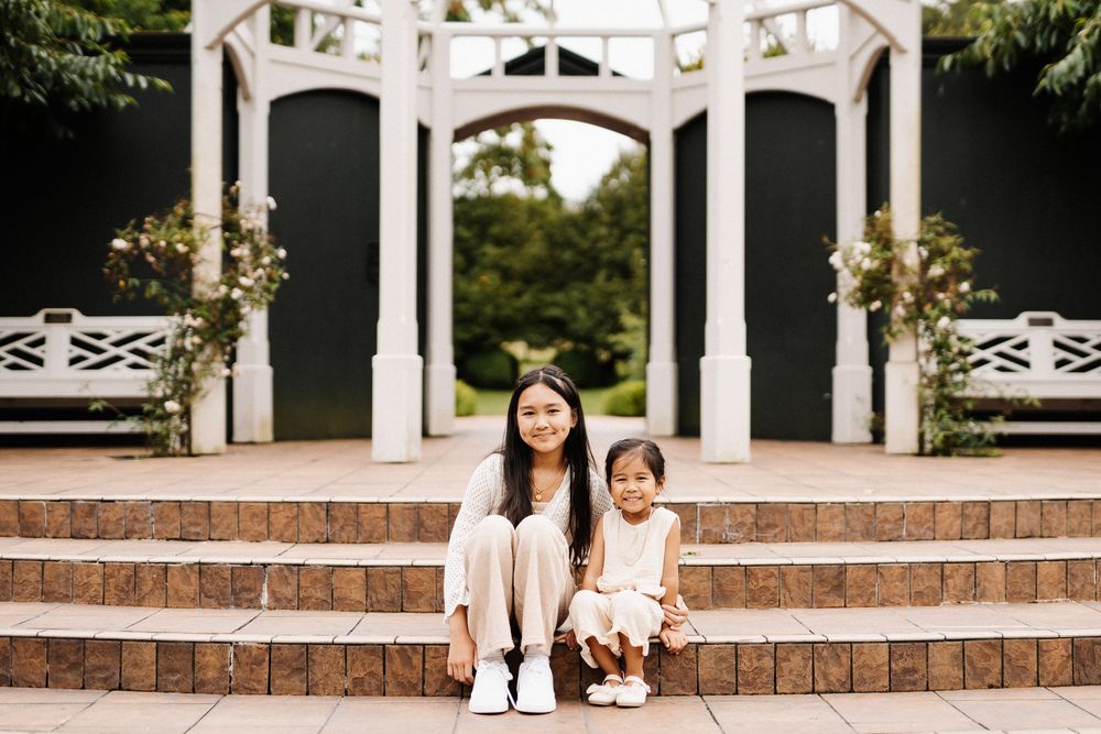Sweet family photos taken in a sequence while sitting on white-trimmed brick steps near a porch.
