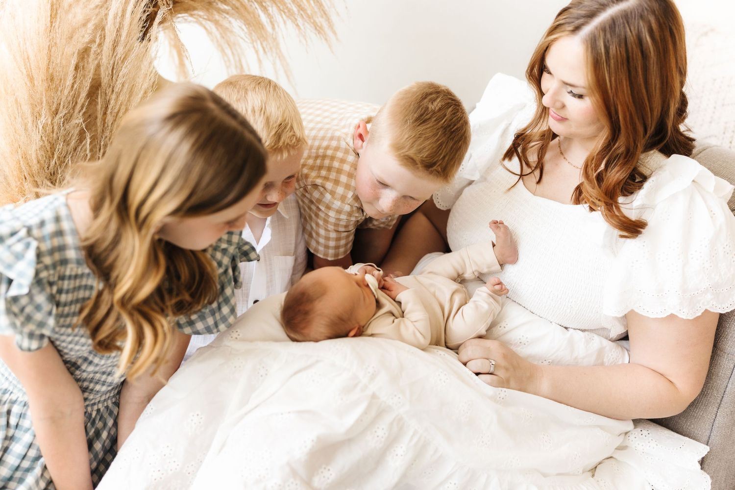 Mother and newborn baby share tender bonding moments during lifestyle photography session. utah family photographer