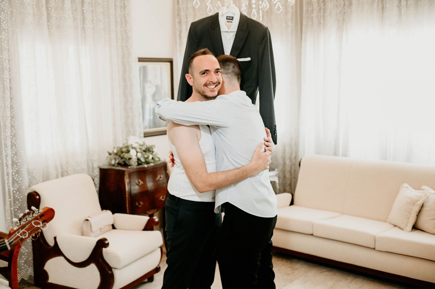 A series of wedding day photos in a bright white room showing couples embracing in formal attire.