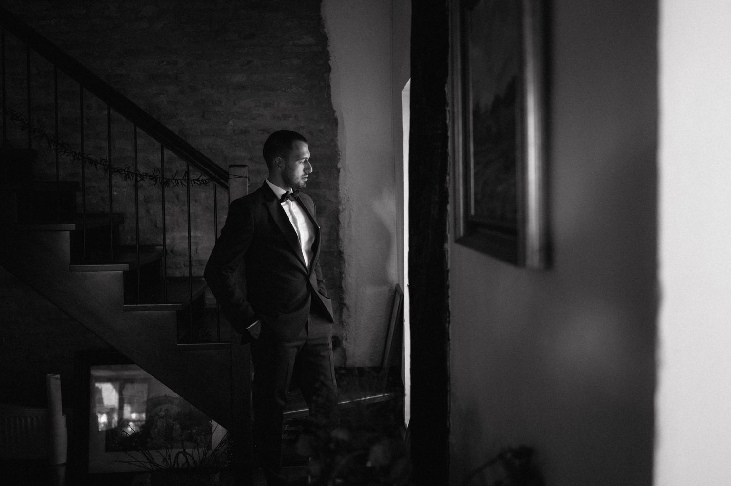 A dramatic black and white film noir style photo sequence shows someone descending a staircase in dark shadows.