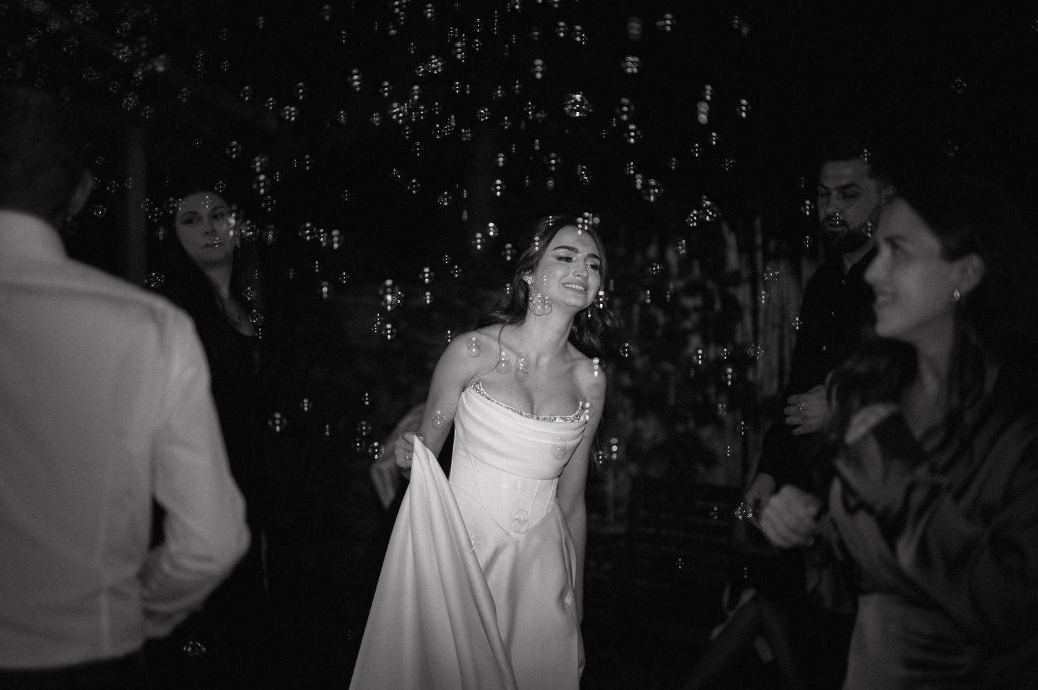 A joyful celebration scene at a party or wedding with sparkling lights and elegant attire.