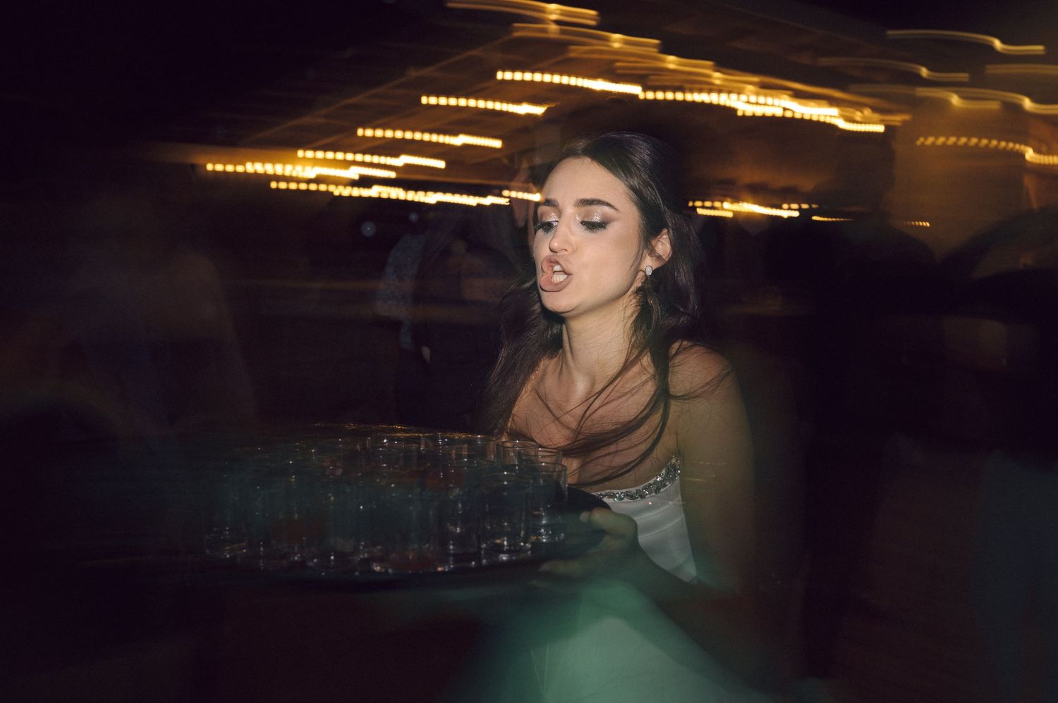 A cinematic sequence shows a silhouette against moody lighting in a dark atmosphere with turquoise accents.