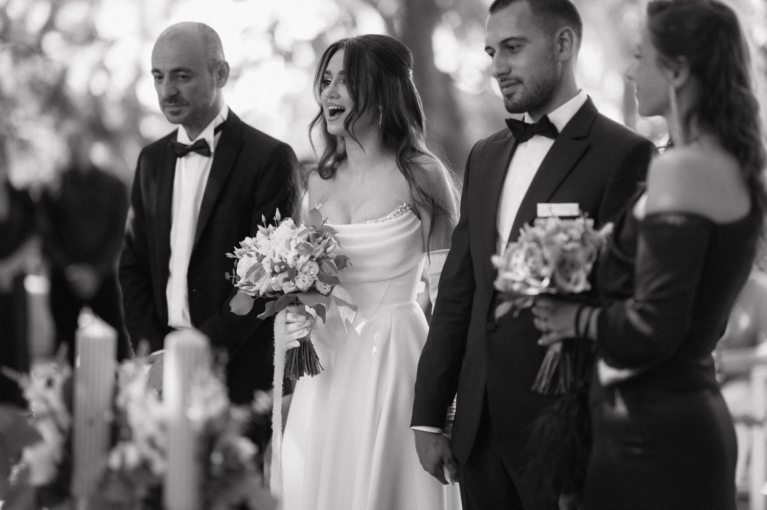 A black and white collage of wedding ceremony moments showing intimate interactions between elegantly dressed couples.