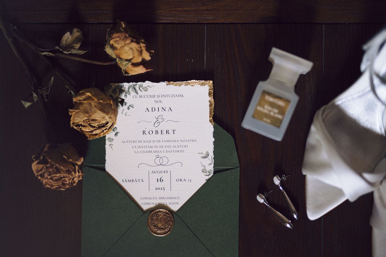 A styled wedding invitation suite featuring calligraphy, gold embellishments, and hexagonal details against a dark background.