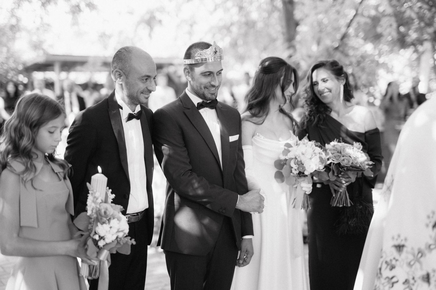 A row of black and white wedding photos showing couples and guests in an elegant venue during celebrations.