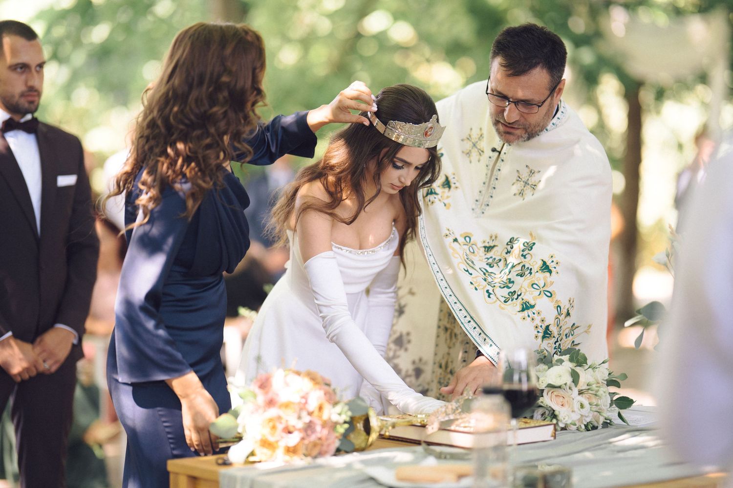 Wedding guests mingle and chat with drinks at an elegant outdoor garden reception.