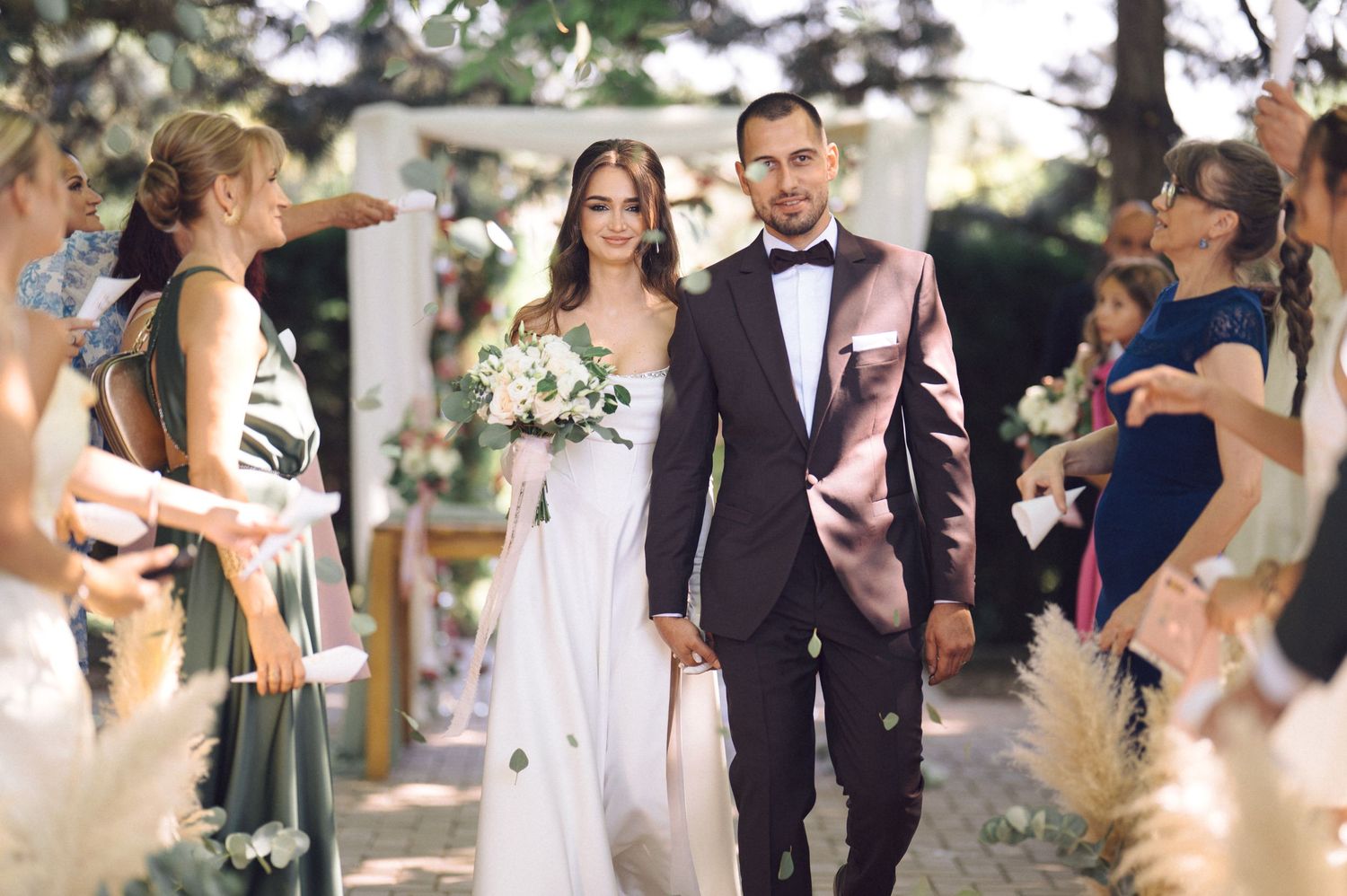 Wedding celebration candids show joyful moments between couples and guests at an outdoor venue.