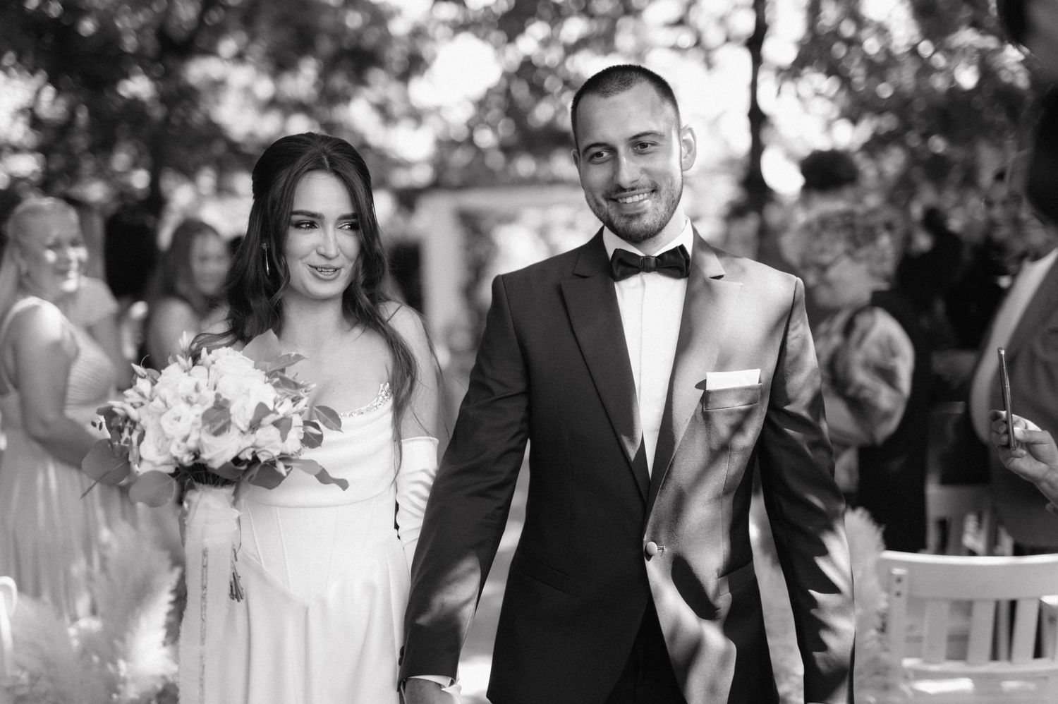 A black and white photo collage of several wedding scenes showing couples celebrating their special day outdoors.