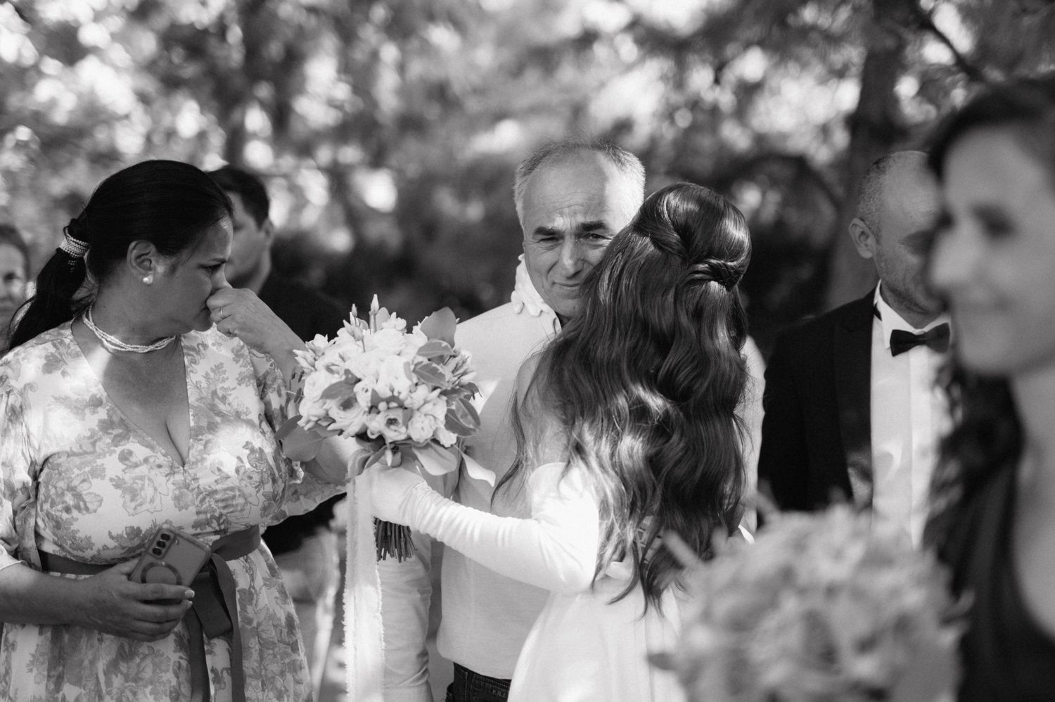 A series of black and white wedding photographs showing romantic moments and details arranged in a collage format.