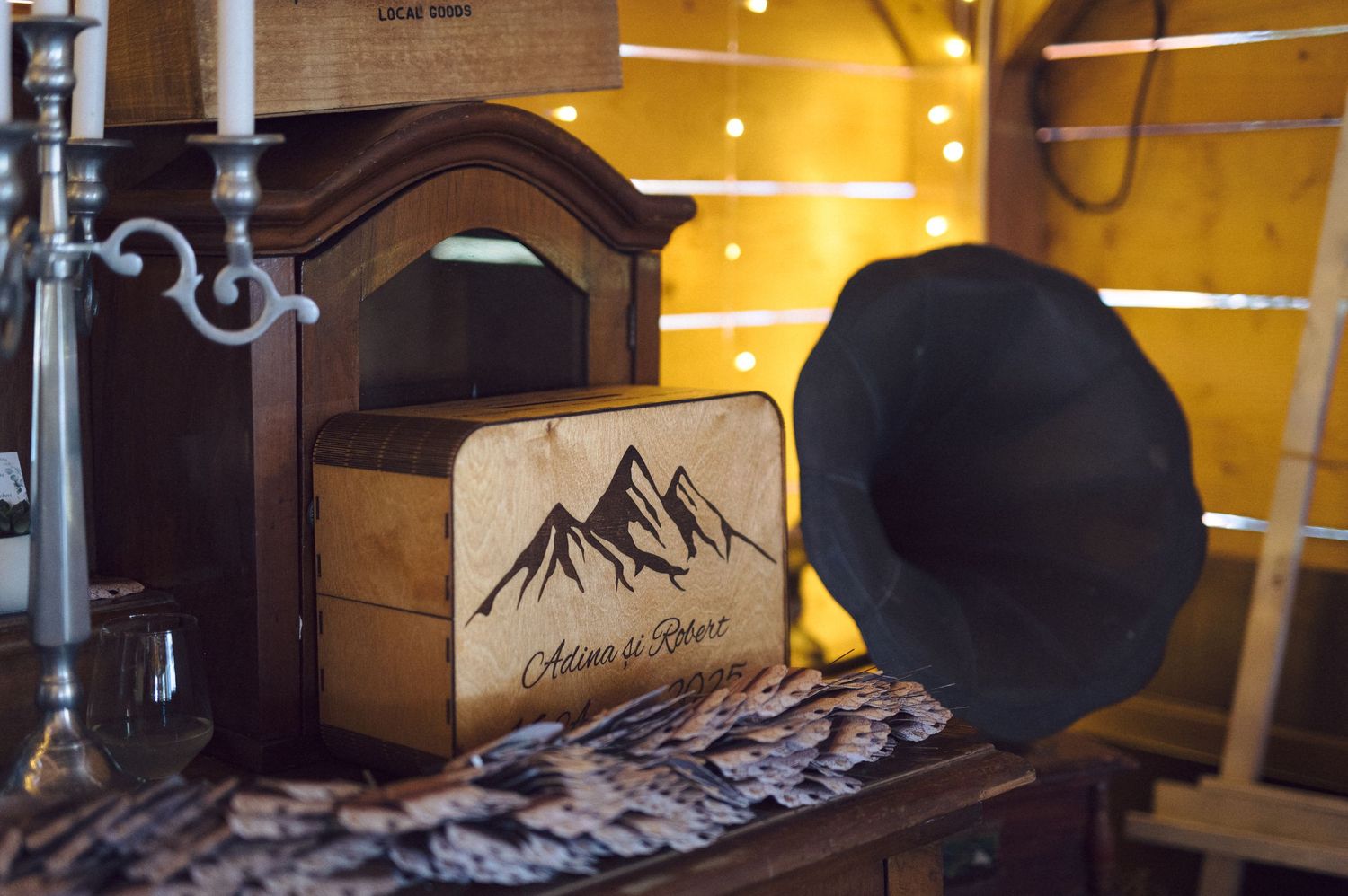 A collection of black fedora hats displayed on wooden shelves in a rustic retail setting with warm lighting.