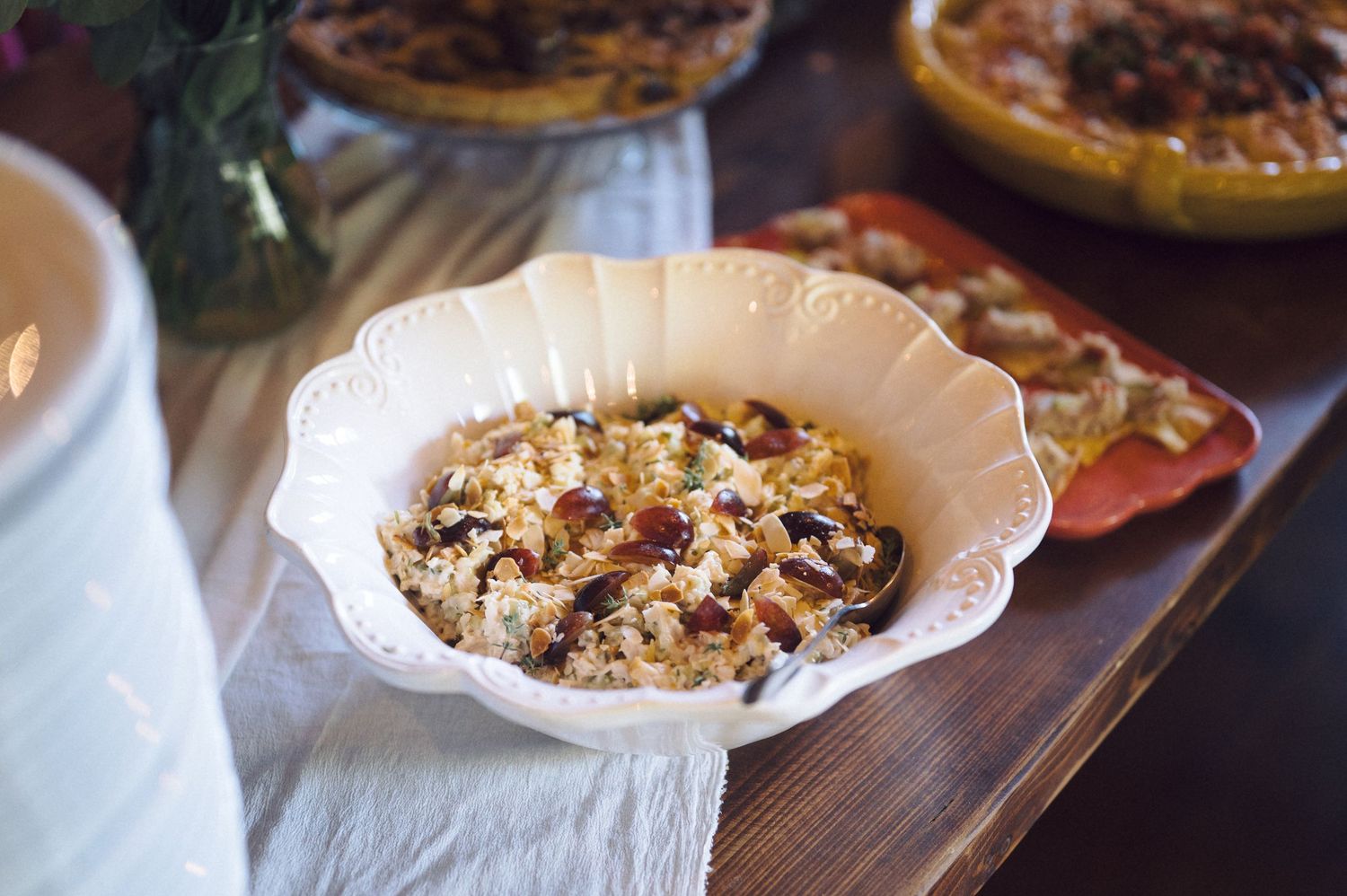 Freshly baked homemade pies and tarts with crispy golden crusts displayed on a rustic wooden table.