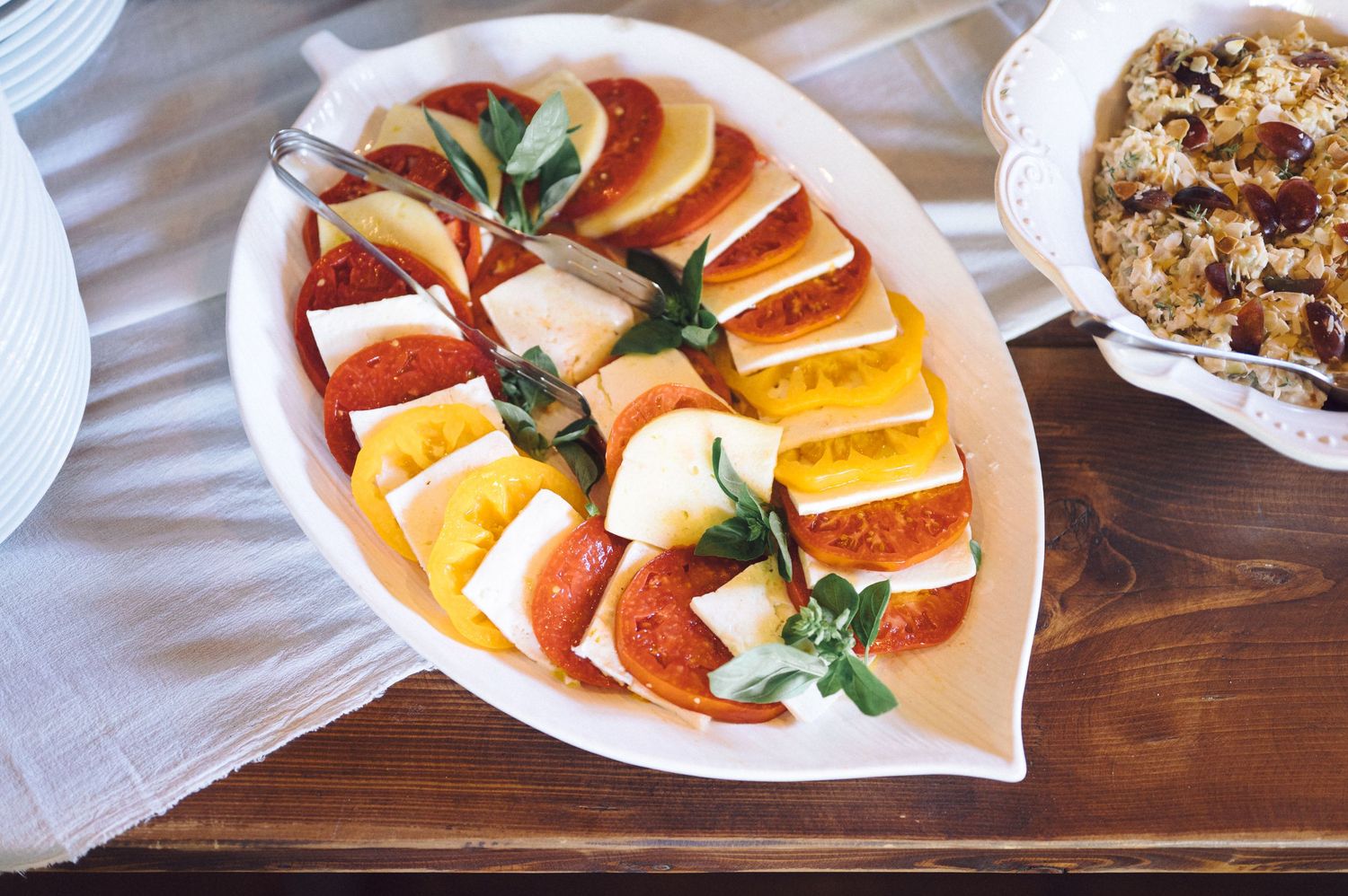 Platter of assorted sliced citrus fruits including oranges and grapefruit garnished with fresh mint leaves on a white plate.