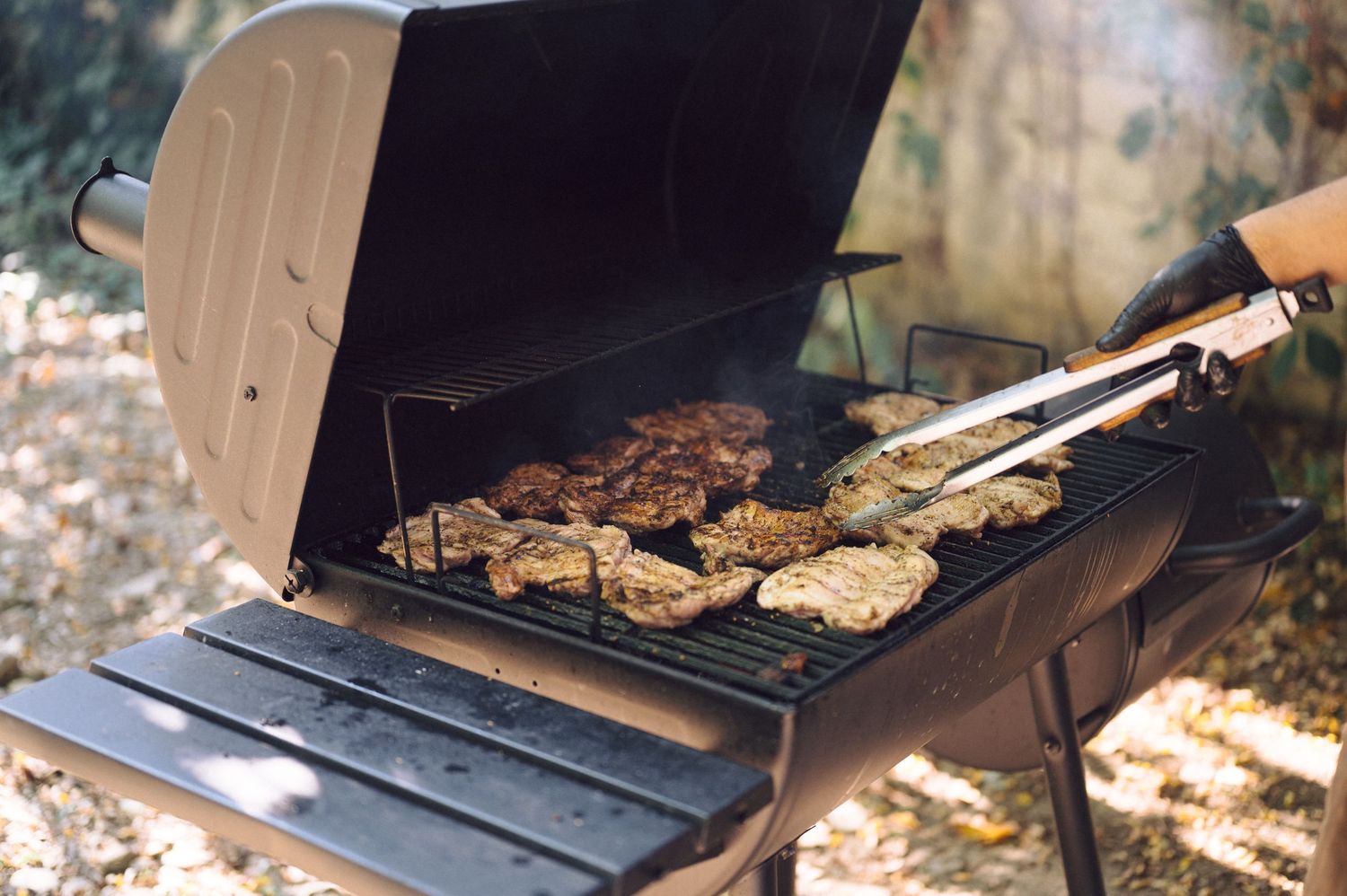 A collection of BBQ and grilling scenes showing meat being cooked on outdoor grills and smokers.