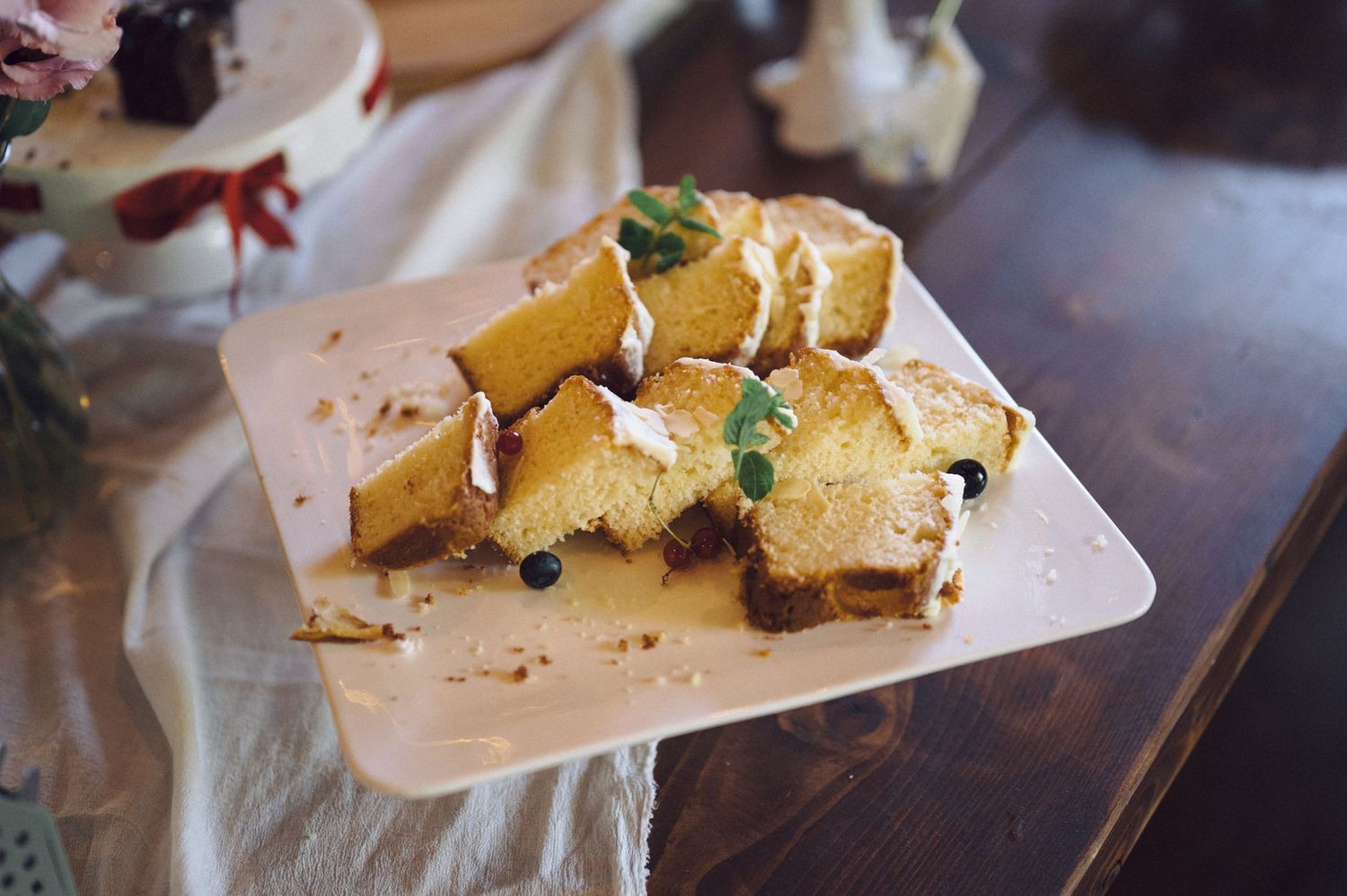 Potato wedges garnished with fresh herbs and spices arranged on parchment paper.