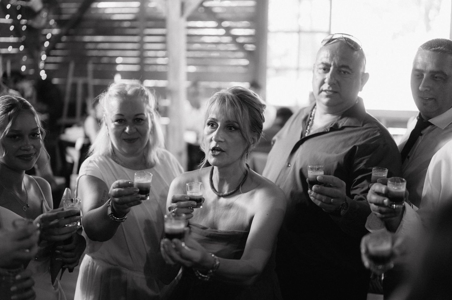 Professional black and white photo series showing people holding up smartphones in a crowd.