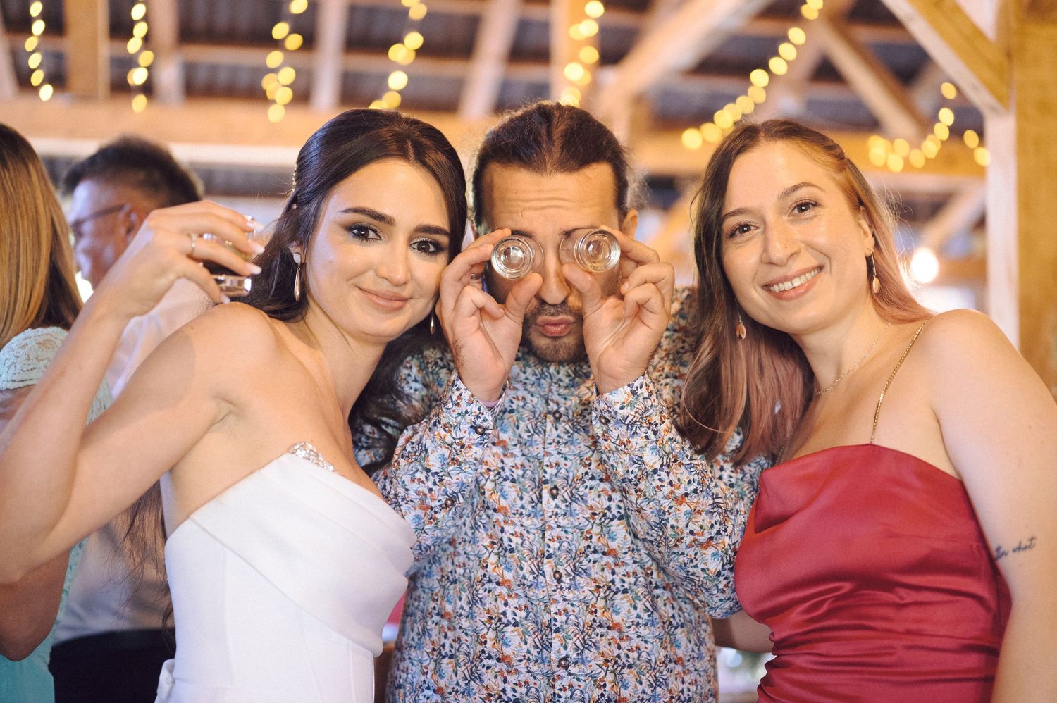 A group of people posing together at a formal event wearing cocktail dresses and evening attire.