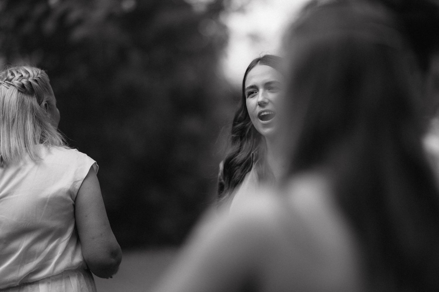 Black and white candid moments captured during an elegant wedding celebration.