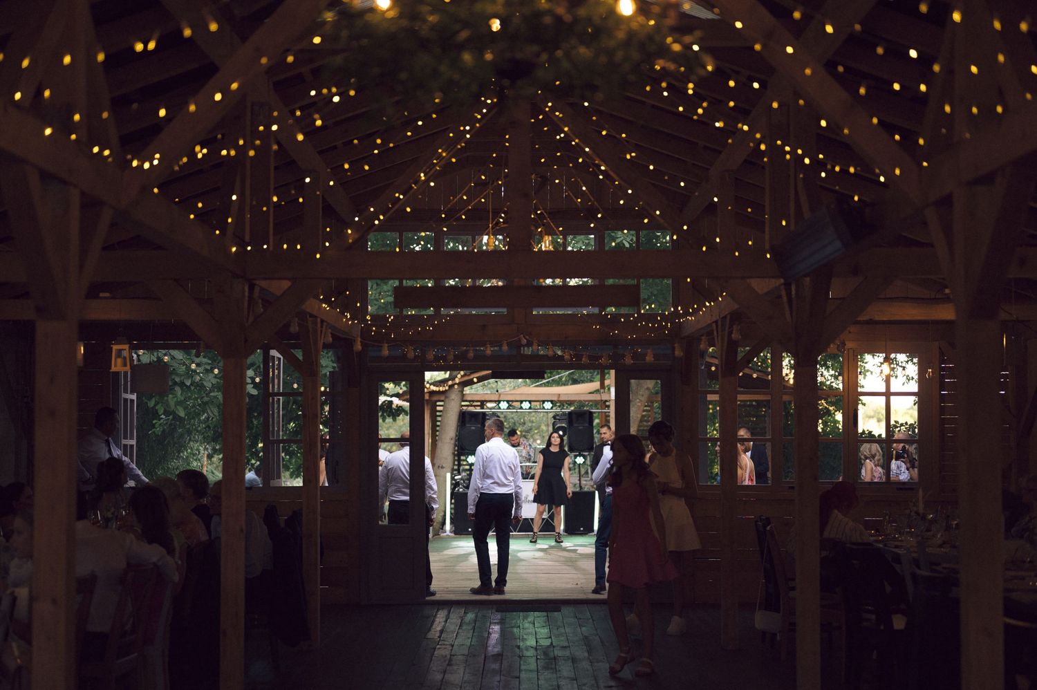 Rustic barn wedding venue decorated with twinkling string lights creating a magical atmosphere.