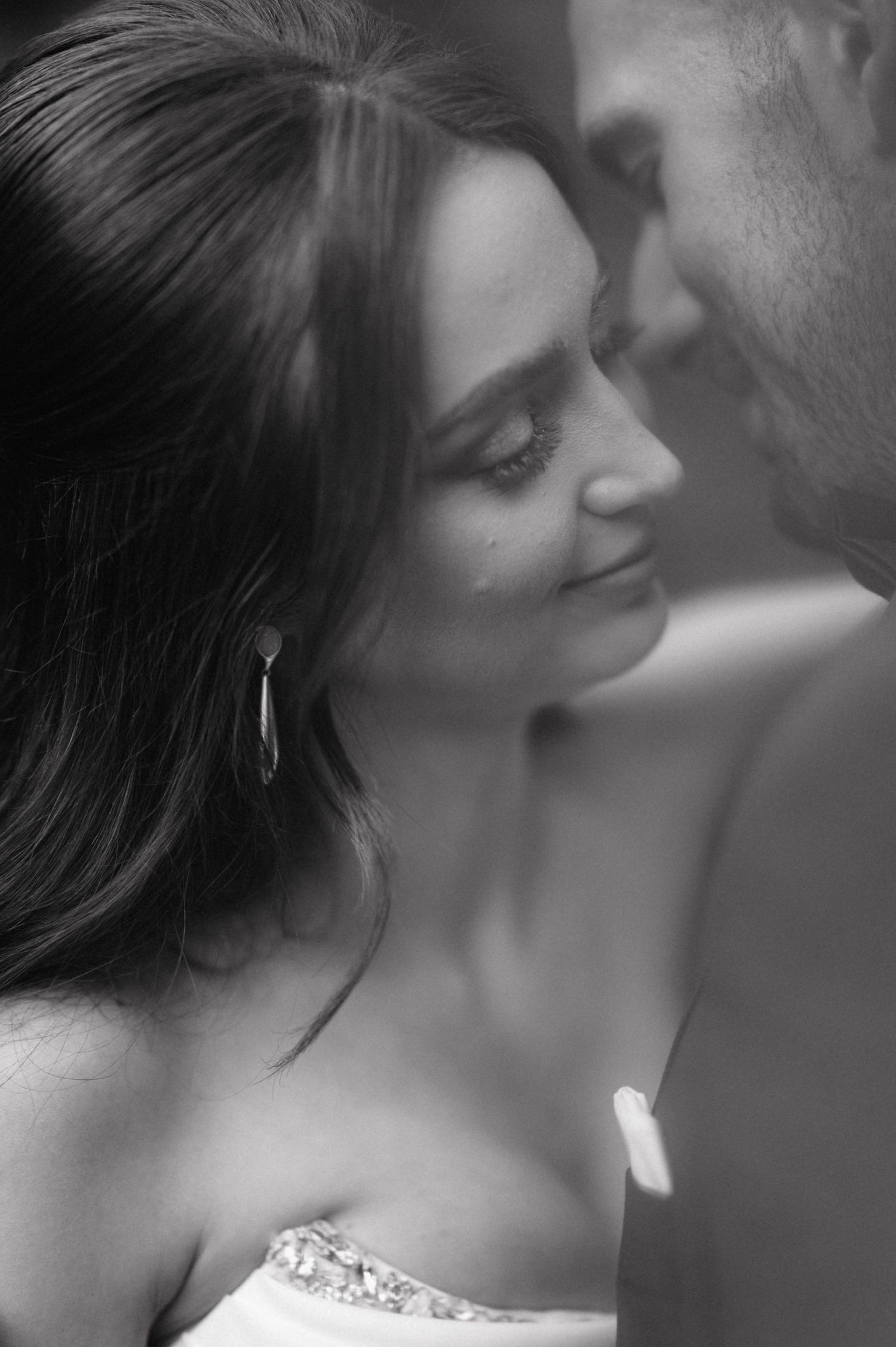 A romantic black and white close-up photo series of an intimate couple sharing tender moments together.