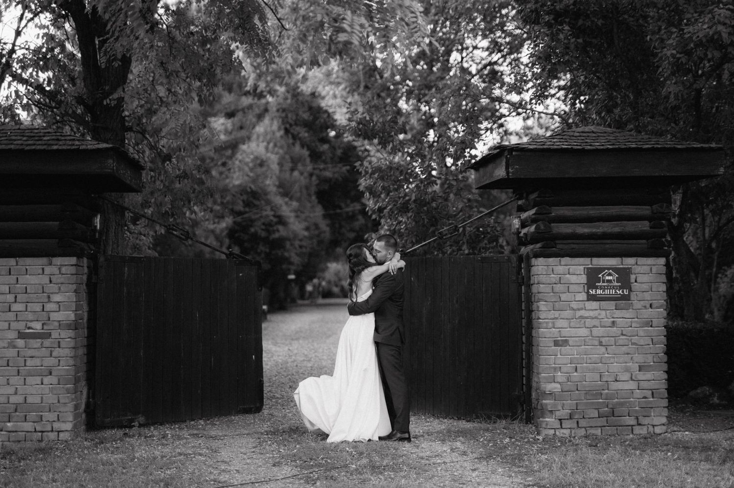 Garden wedding venue with brick pillars and natural landscaping.