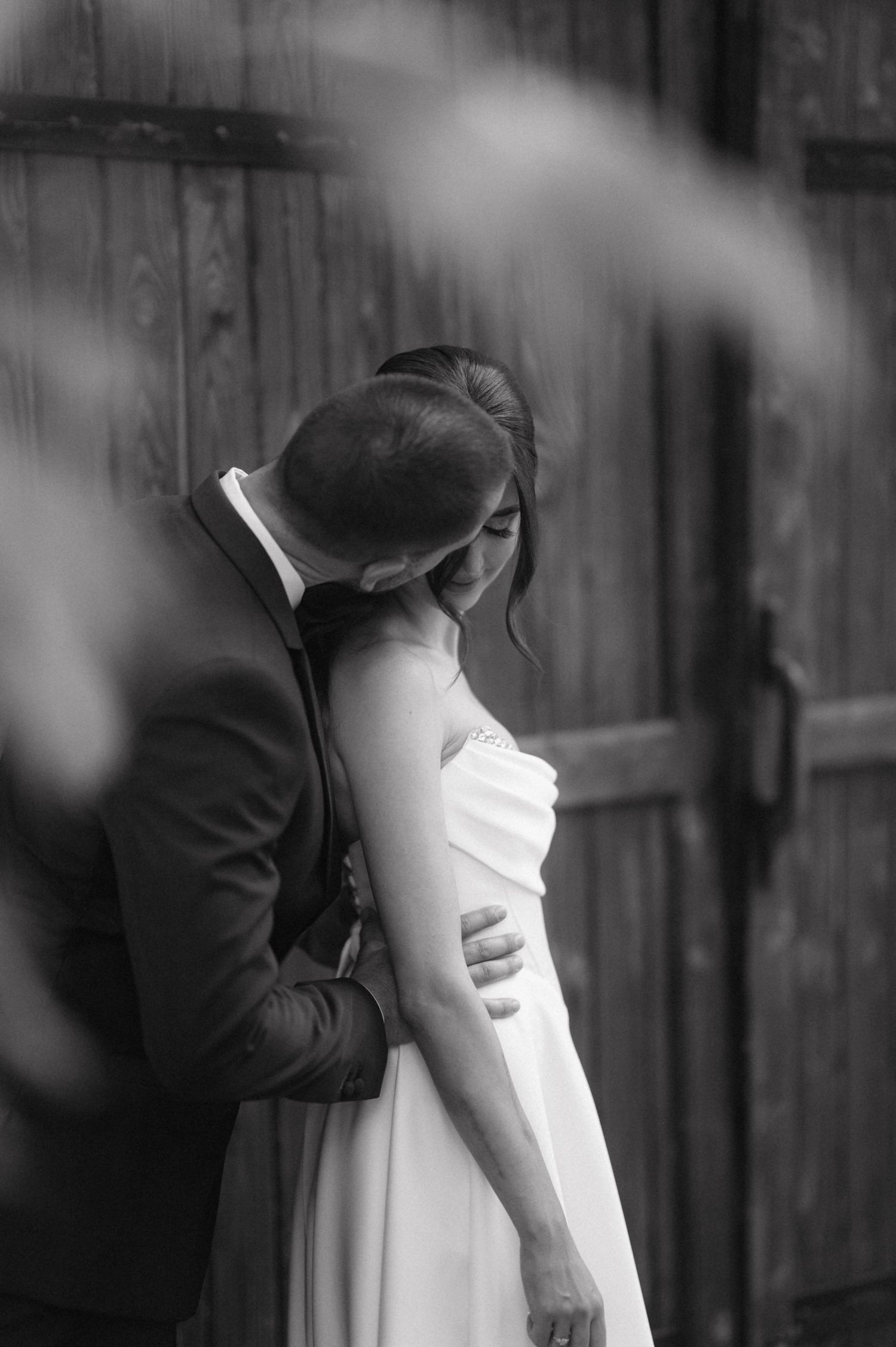 Romantic black and white photo sequence showing couple embracing during an intimate wedding moment.
