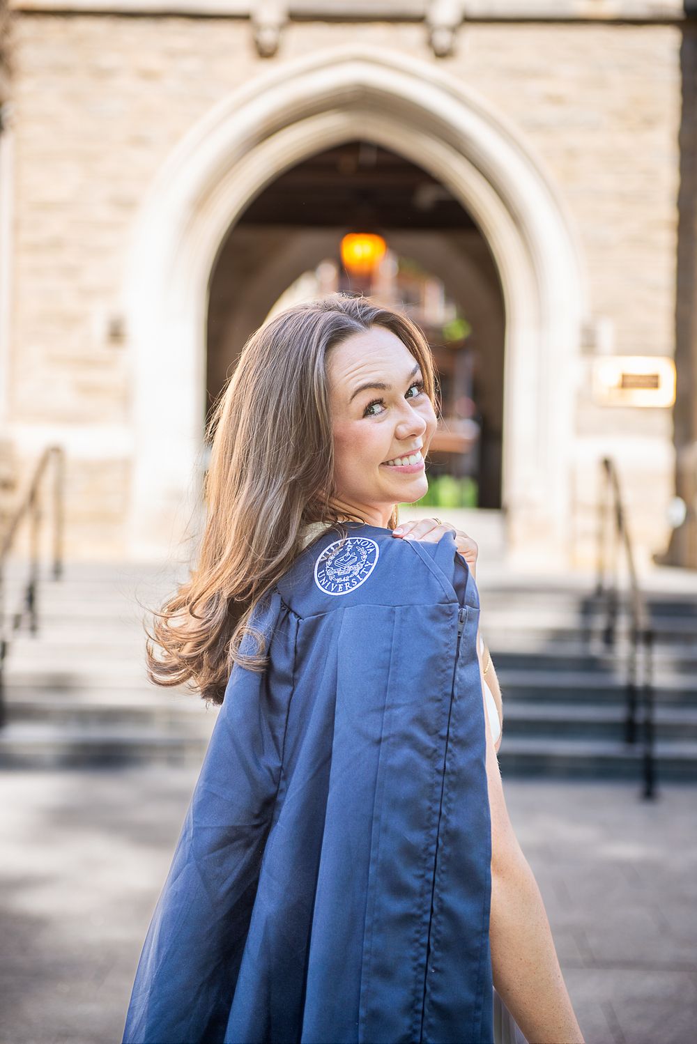 A sequence of photos showing a person in a navy blue jacket walking and turning in front of an arched building.