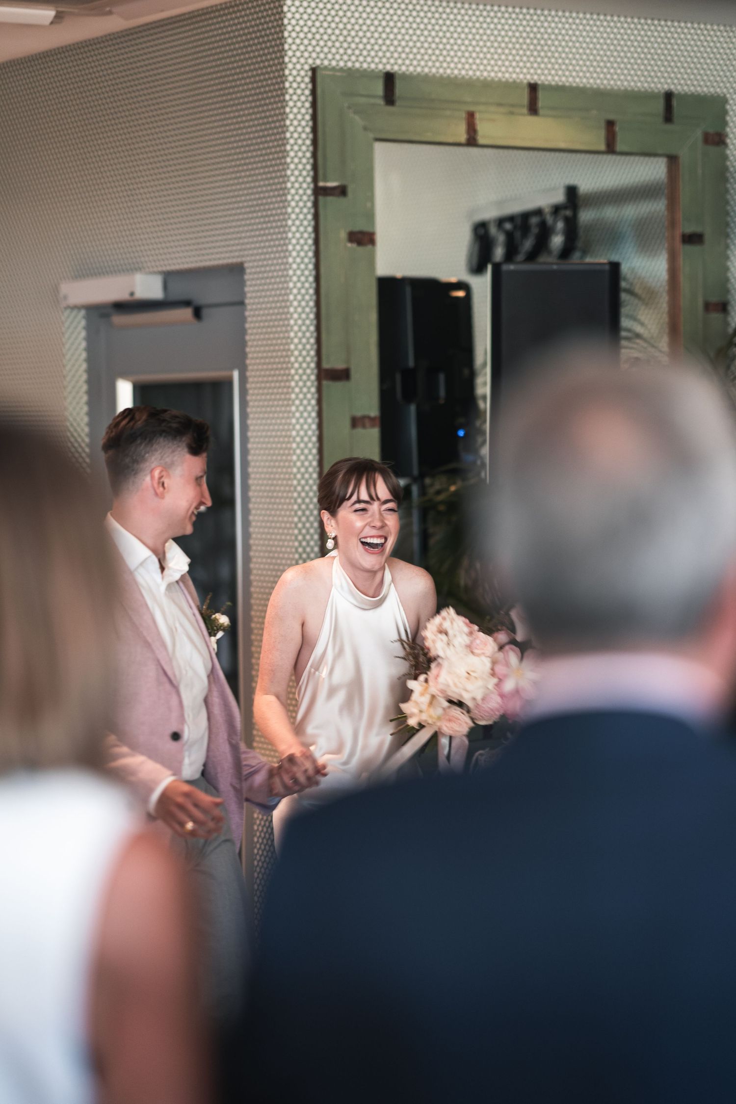 Wedding celebration captured through a crowd with joyful reactions.