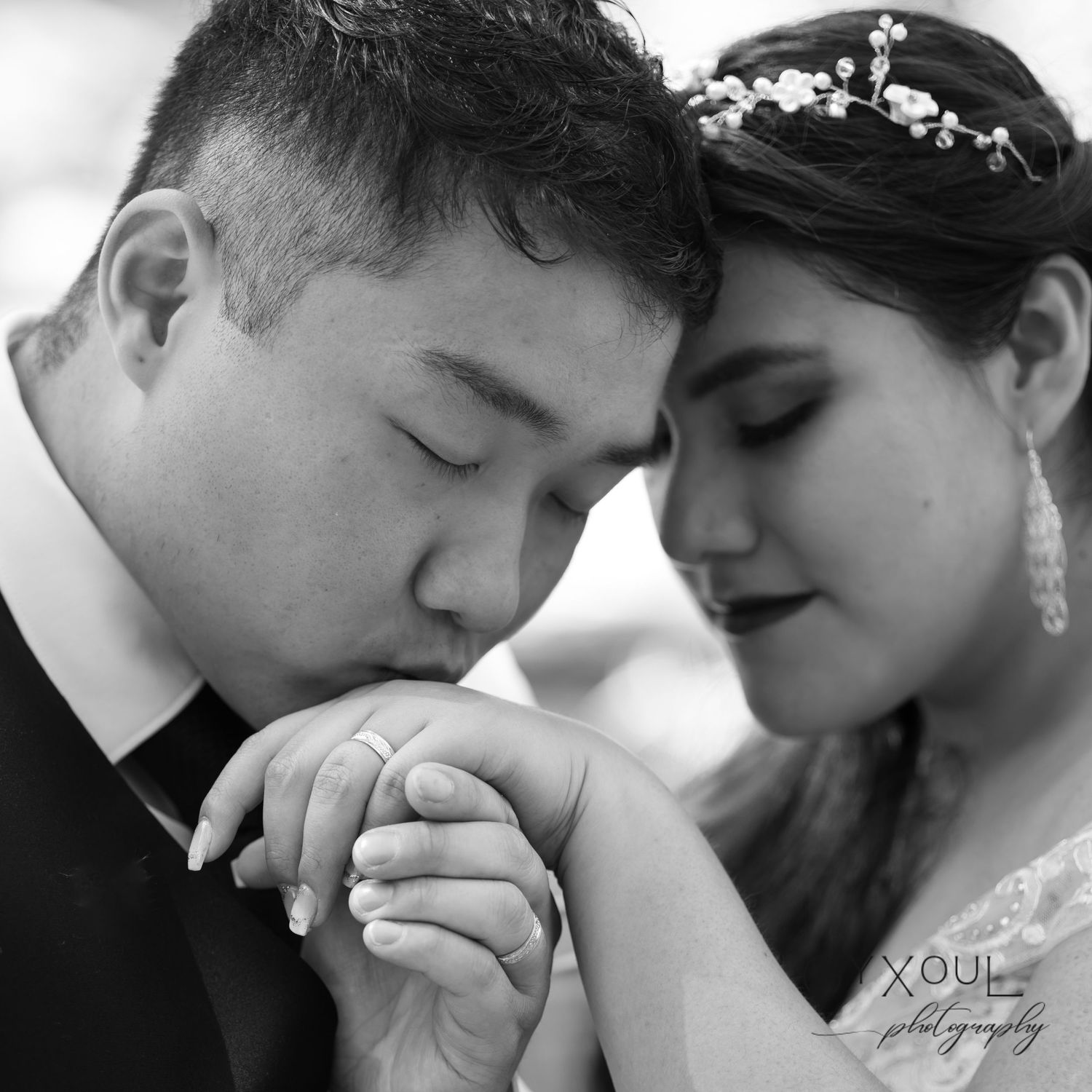 Intimate black and white wedding portrait showing tender moment.