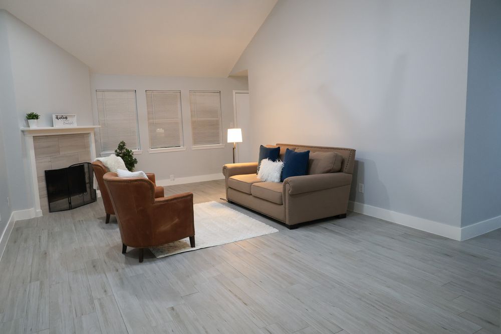 Contemporary living space with light wood flooring, neutral walls, and modern furnishings.