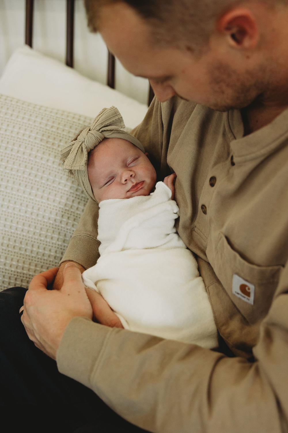 A tender moment captured in a series of photos showing a parent in beige clothing cradling a sleeping newborn in white.
