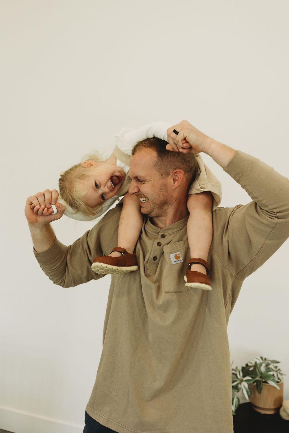Three sequential photos show someone in a beige sweater making exaggerated gestures of pinching their nose in disgust.