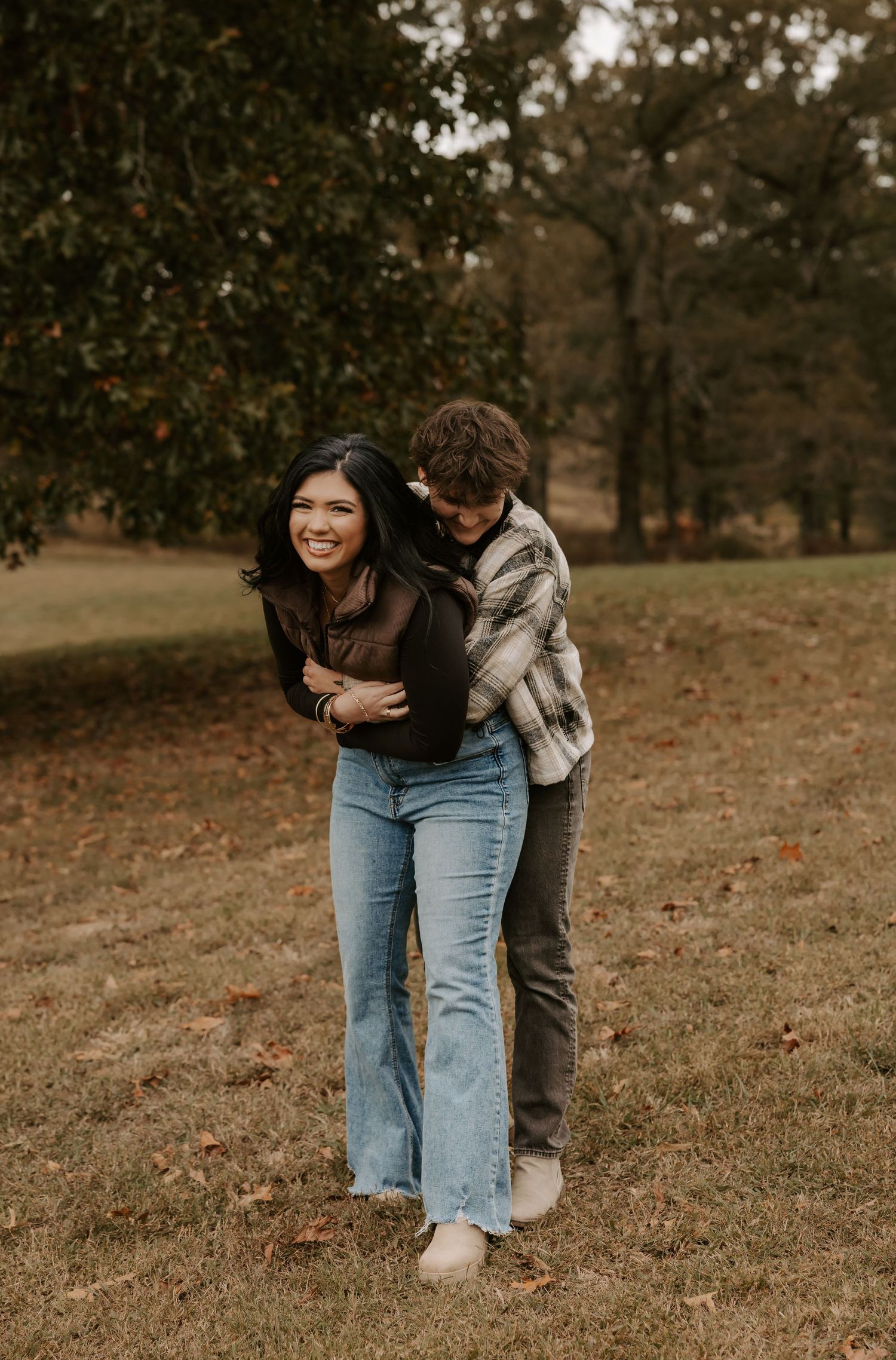 Playful outdoor couple photography sequence showing joyful interaction in an autumn setting.