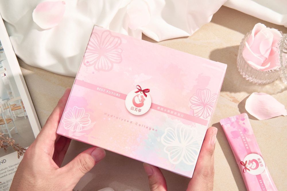 Soft pink and white decorative paper elements arranged in a delicate composition against a light background.