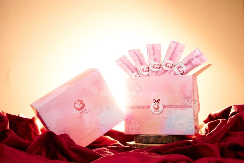 Pink stationery products displayed against a warm gradient background with dramatic lighting.