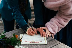 A couple signs their marriage certificate at their Elopement, captured by Savvy Photography - Seattle Wedding Photographer