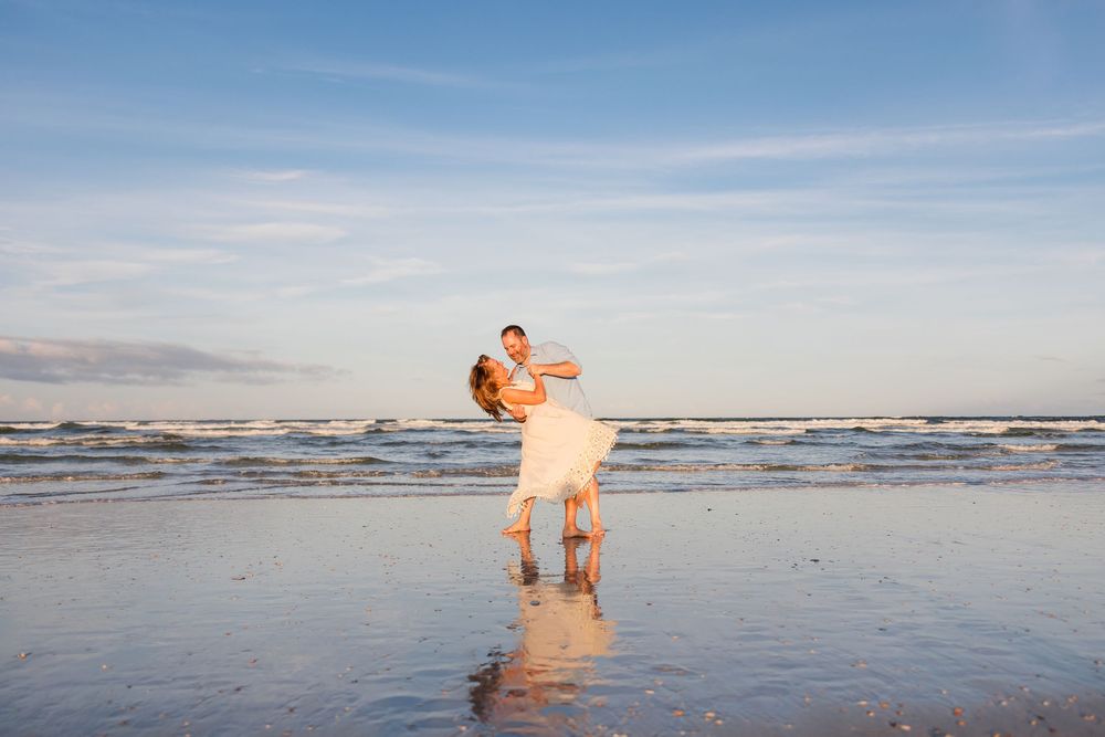 Family members enjoying the beach at sunset with waves rolling in.