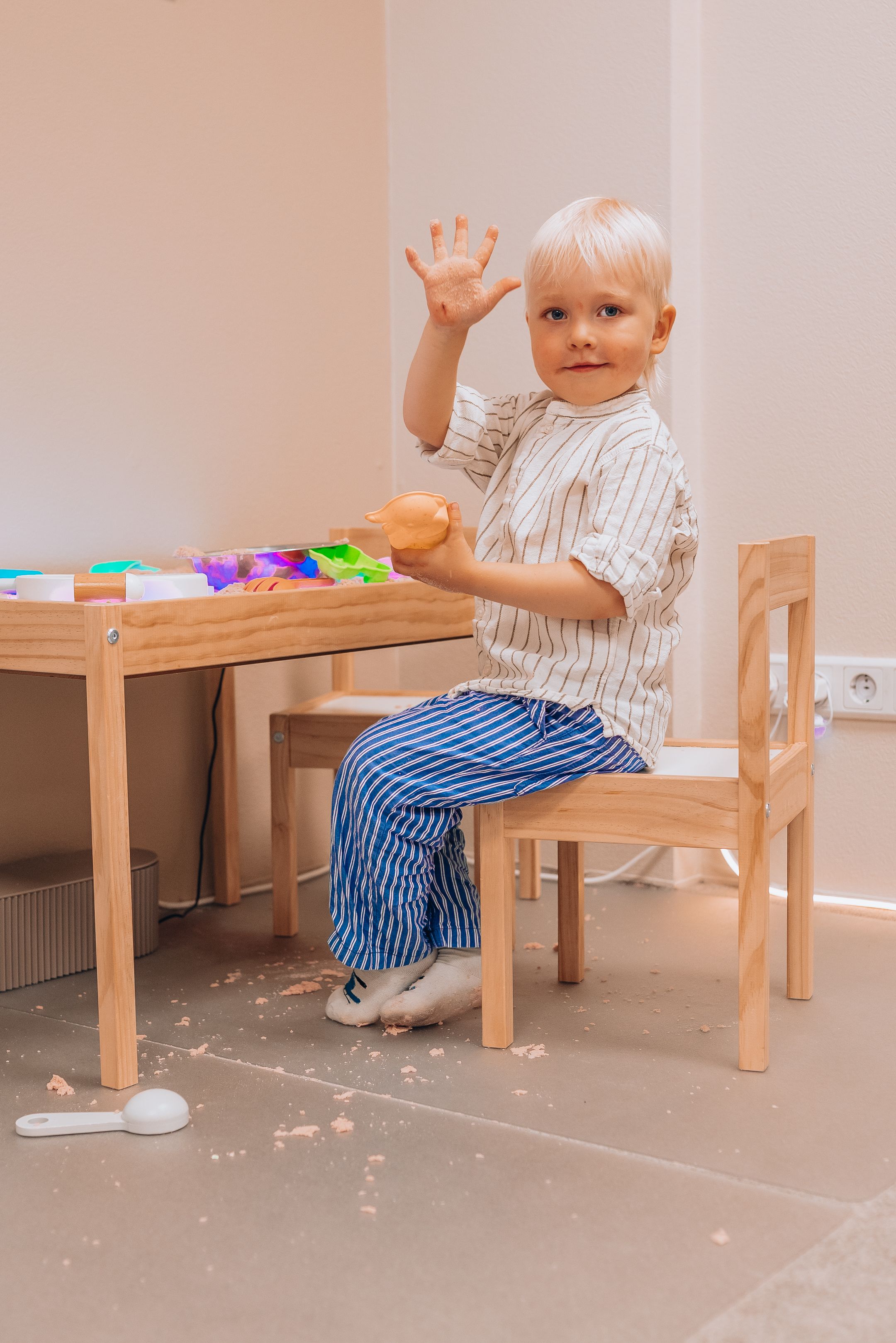A sequence of photos showing a toddler in striped clothing climbing onto a wooden chair in a light-colored room.