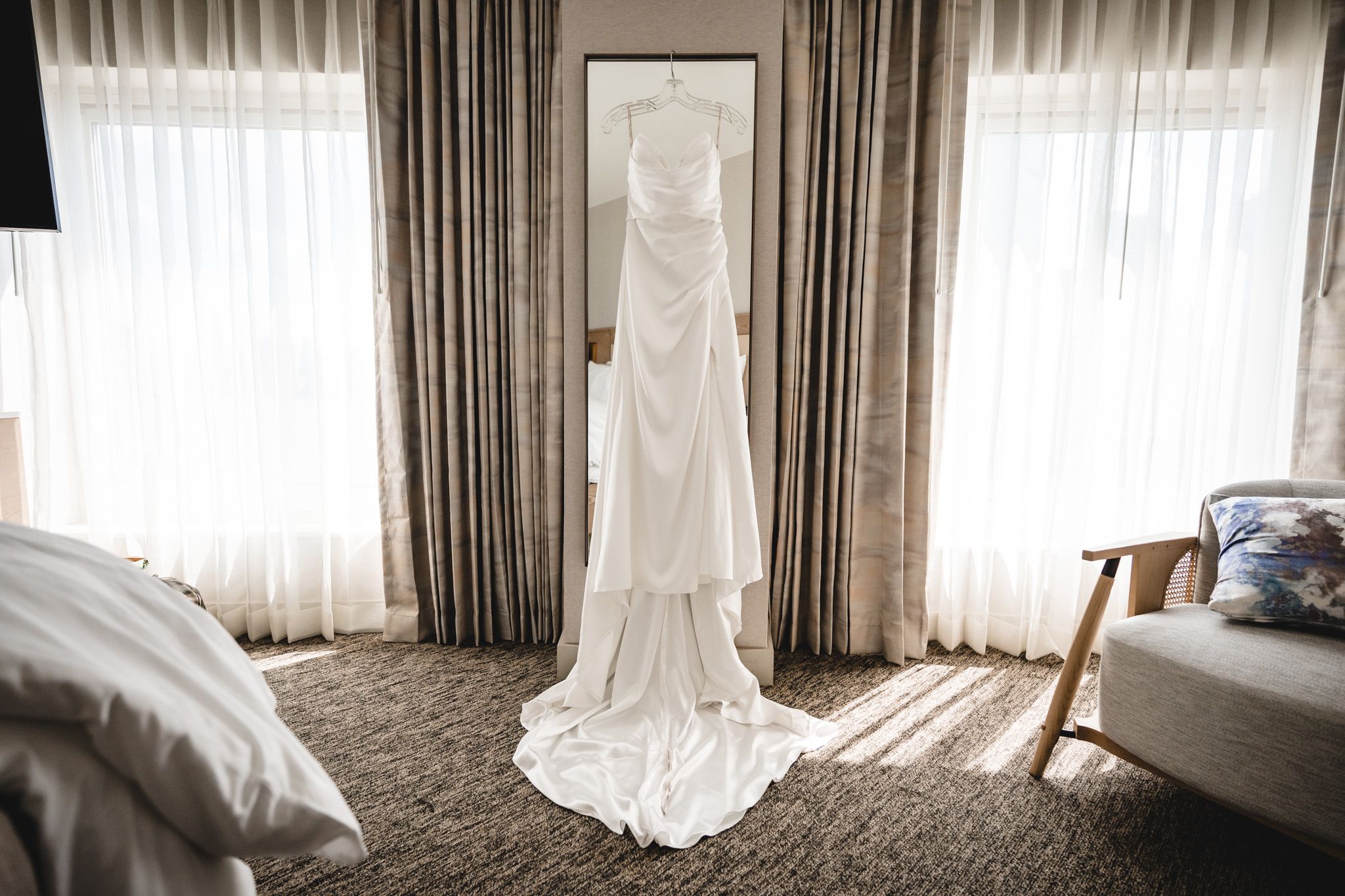 Sunlit room with flowing white curtains and elegant interior decor.
