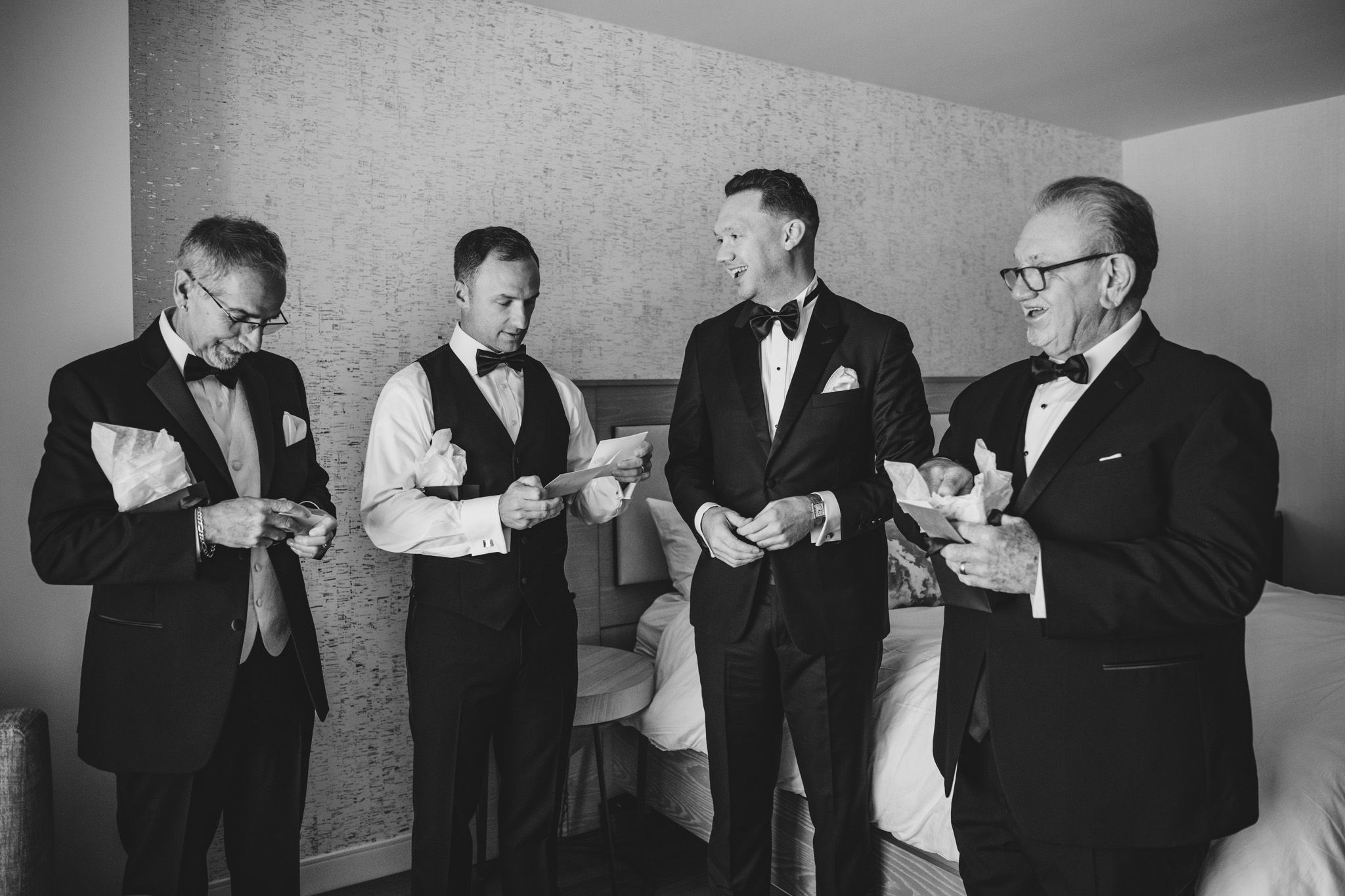 Group shots of people in suits helping each other prepare for a formal event.