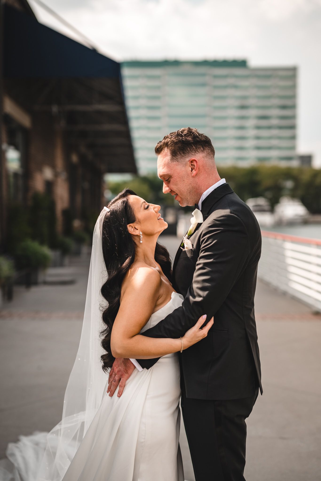 Romantic black and white wedding portrait series showing intimate moments between newlyweds on an urban rooftop.